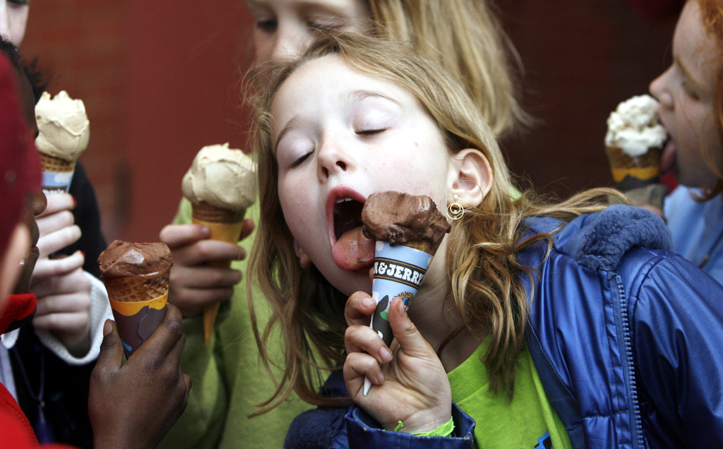 FILE - A youngster eats an ice cream cone in front of the Ben & Jerry's ice cream shop in Montpelier, Vt., April 25, 2006. (AP Photo/Toby Talbot, File)