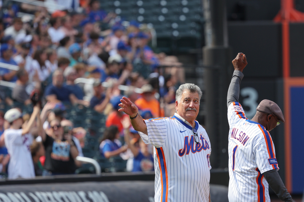 Keith Hernandez, left, acknowledges the crowd next to Mookie Wilson during a celebration for the 1986 New York Mets team that won a World Series, Saturday, Aug. 1, 2026, in New York. (AP Photo/Heather Khalifa)