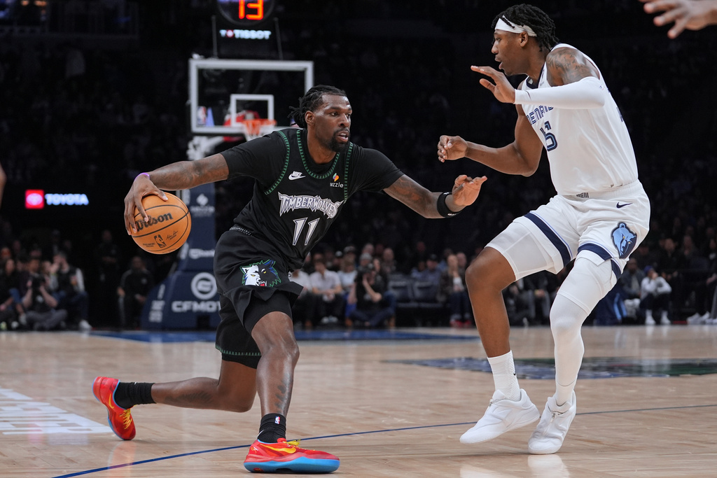 Minnesota Timberwolves center Naz Reid (11) works toward the basket as Memphis Grizzlies forward GG Jackson defends during the first half of an NBA basketball game, Tuesday, March 3, 2026, in Minneapolis. (AP Photo/Abbie Parr)