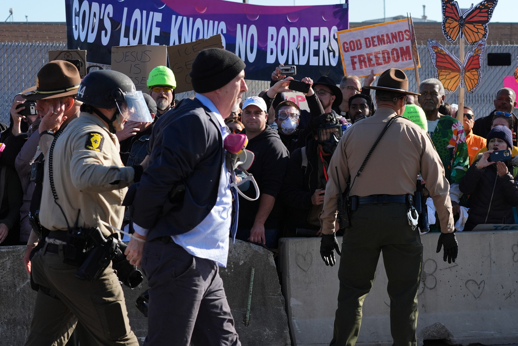 Cook County Sheriff Police guard as Illinois State police detain a protester outside an ICE processing facility in the Chicago suburb of Broadview, Ill., Friday, Nov. 14, 2025. (AP Photo/Nam Y. Huh)