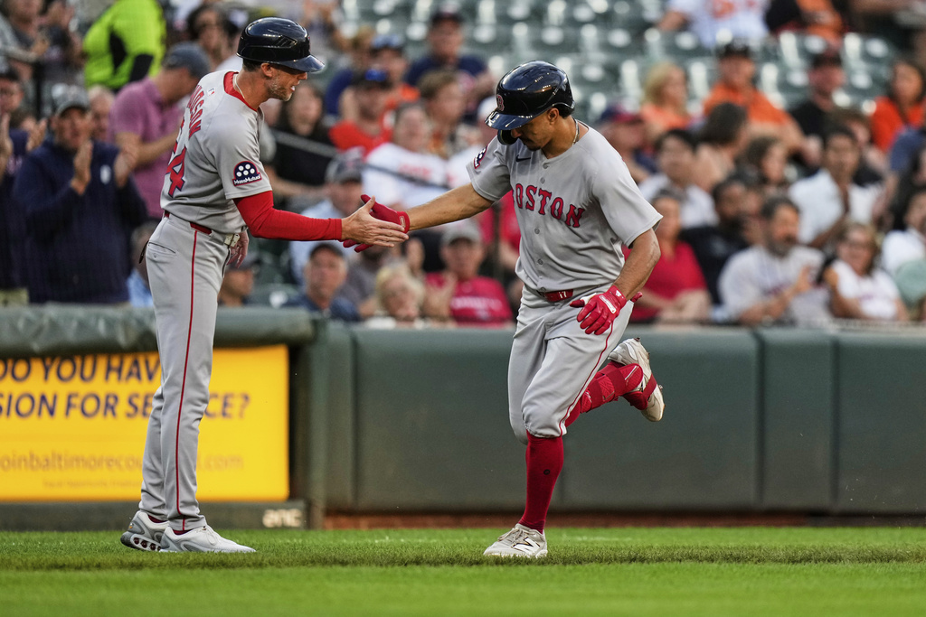 Boston Red Sox's David Hamilton, right, celebrates with third base coach/outfield instructor Kyle Hudson after hitting a home run during the third inning of a baseball game against the Baltimore Orioles, Tuesday, Aug. 26, 2025, in Baltimore. (AP Photo/Stephanie Scarbrough)