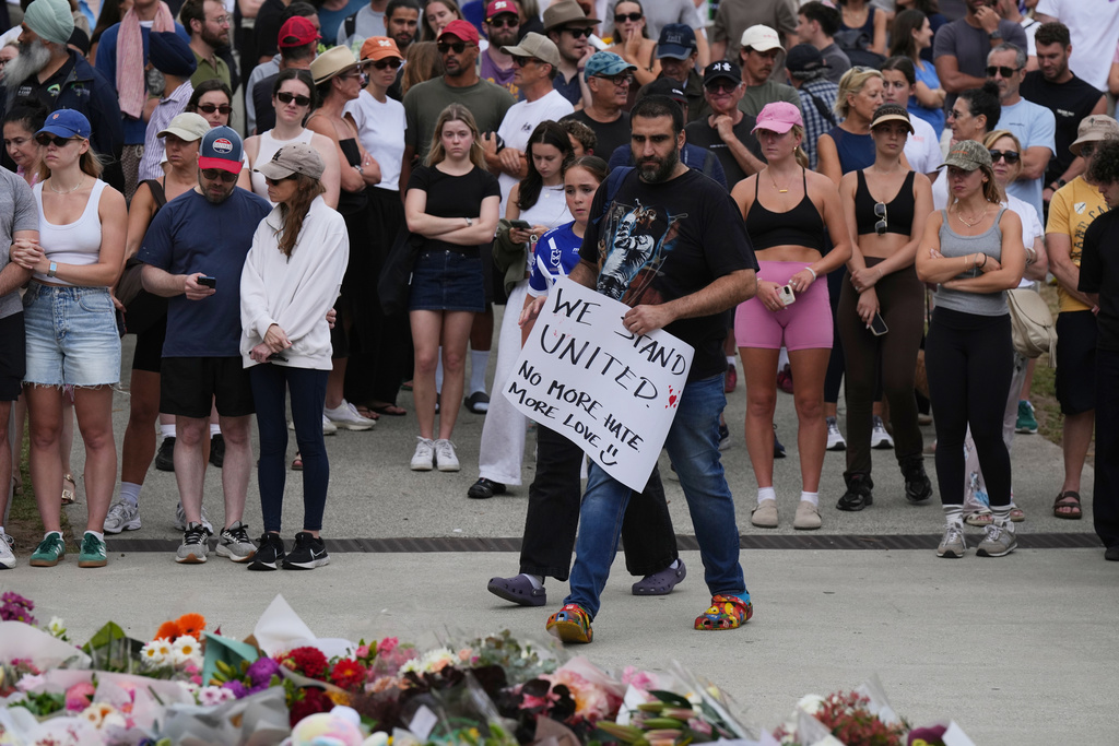 People leave notes at a flower tribute for shooting victims outside the Bondi Pavilion at Sydney's Bondi Beach, Monday, Dec. 15, 2025, a day after a shooting. (AP Photo/Mark Baker)