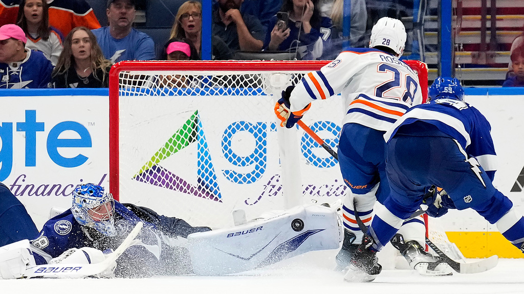 Tampa Bay Lightning goaltender Andrei Vasilevskiy (88) makes a pad save on a shot by Edmonton Oilers center Jack Roslovic (28) during overtime of an NHL hockey game Thursday, Nov. 20, 2025, in Tampa, Fla. (AP Photo/Chris O'Meara)