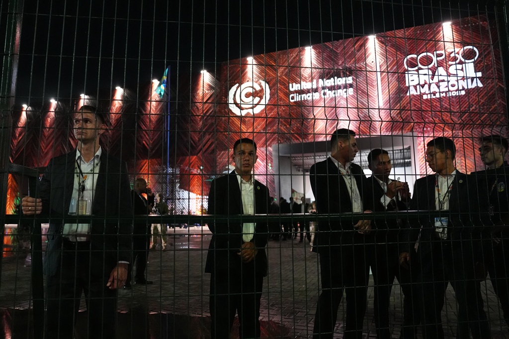 Security personnel stand behind a fence outside the venue for the COP30 U.N. Climate Summit, Tuesday, Nov. 11, 2025, in Belem, Brazil. (AP Photo/Joshua A. Bickel)