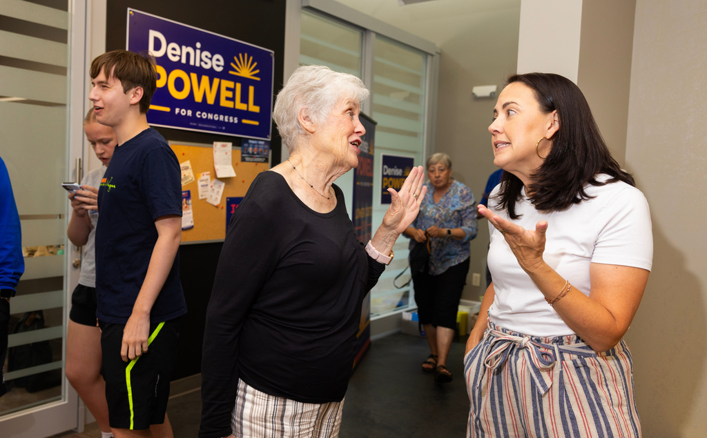 Kathy Bigsby Moore, left center, chats with Denise Powell, the Democratic candidate for the House of Representatives in Nebraska's second congressional district, during an event celebrating Powell's new campaign office in Omaha, Neb., Saturday, Aug. 15, 2026. (AP Photo/Rebecca S. Gratz)