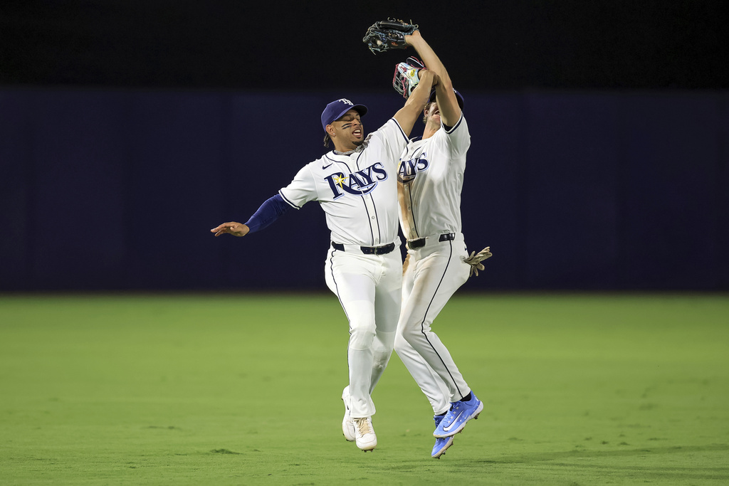 Tampa Bay Rays shortstop Carson Williams, right, makes a catch over outfielder Christopher Morel on a pop up from Toronto Blue Jays' Addison Barger during the fourth inning of a baseball game Wednesday, Sept. 17, 2025, in Tampa, Fla. (AP Photo/Mike Carlson)
