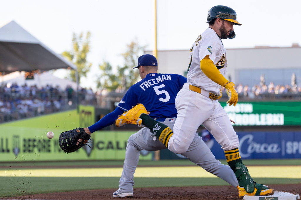 Los Angeles Dodgers first baseman Freddie Freeman (5) attempts to force out Athletics' Shea Langeliers at during the first inning of a baseball game Tuesday, June 30, 2026, in West Sacramento, Calif. (AP Photo/Sara Nevis)