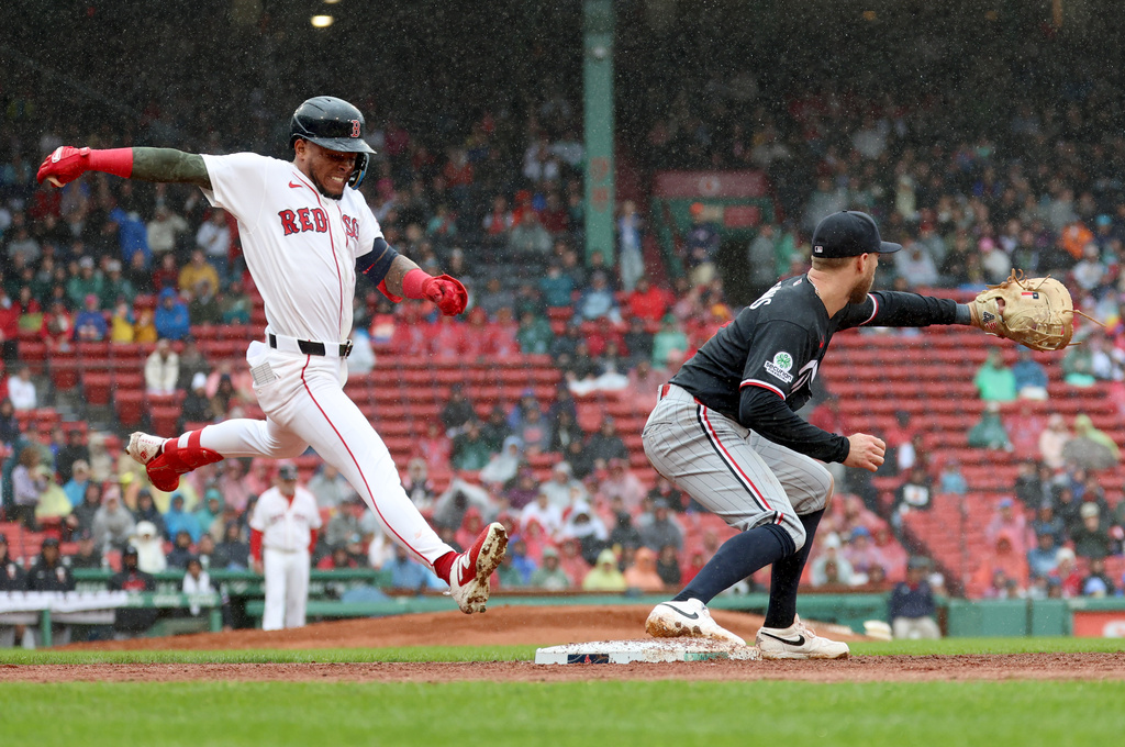 Minnesota Twins first baseman Kody Clemens, right, makes an out against Boston Red Sox's Ceddanne Rafaela, left, during the third inning of a baseball game, Sunday, May 24, 2026, in Boston. (AP Photo/Mark Stockwell)