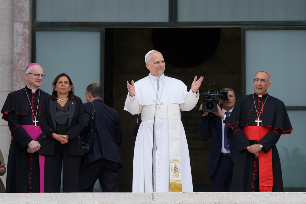 Pope Leo XIV, accompanied by, from left, Prefect of the Pontifical Household Archbishop Petar Rajič, Dean Antonella Polimeni, and his vicar for the city of Rome Cardinal Baldo Reina, visits the Città Universitaria (University City) at Sapienza University of Rome to meet with faculty and students at the institution's primary campus, one of the world's oldest and largest universities, Thursday, May 14, 2026. (AP Photo/Gregorio Borgia)