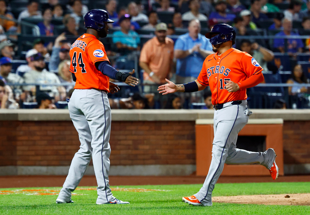 Houston Astros Yordan Alvarez (44) and Isaac Paredes shake hands after scoring against the New York Mets during the sixth inning of a baseball game, Friday, August 28, 2026, in New York. (AP Photo/Noah K. Murray)