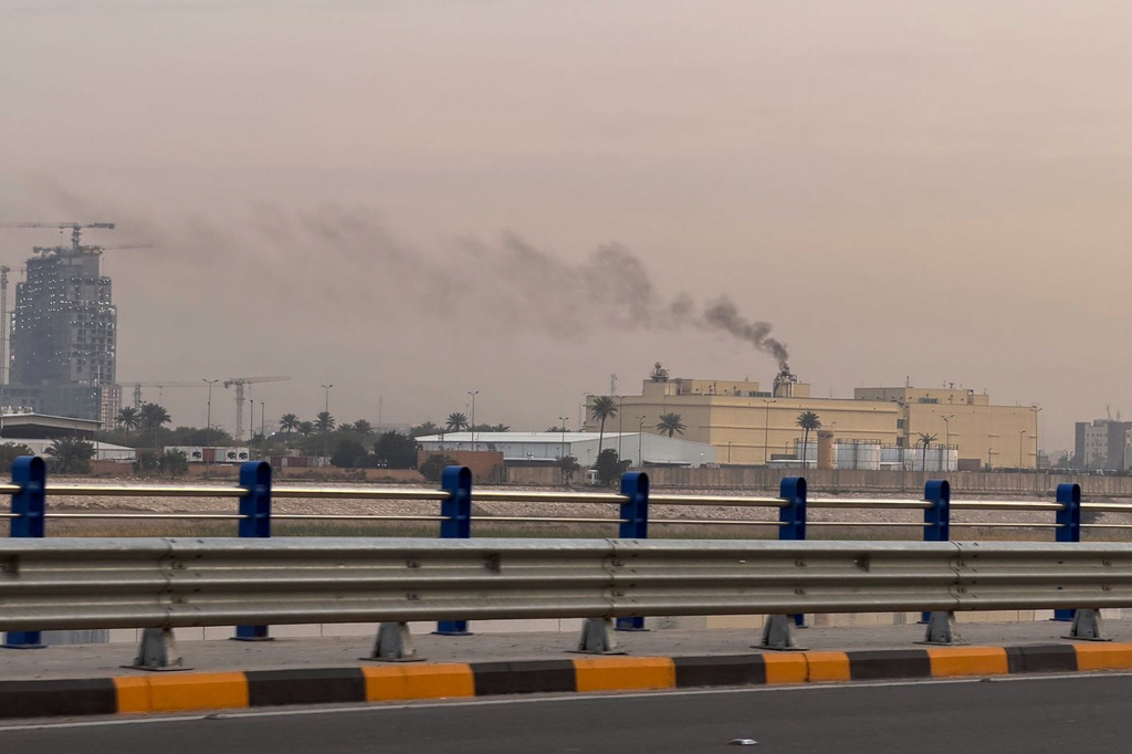 Smoke rises from the U.S. embassy building in Baghdad, Iraq, Saturday, March 14, 2026. (AP Photo/Ali Jabar)