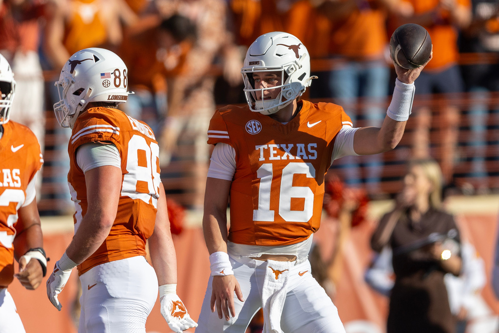 Texas quarterback Arch Manning (16) celebrates his touchdown against Arkansas during the first half of an NCAA college football game Saturday, Nov. 22, 2025, in Austin, Texas. (AP Photo/Stephen Spillman)