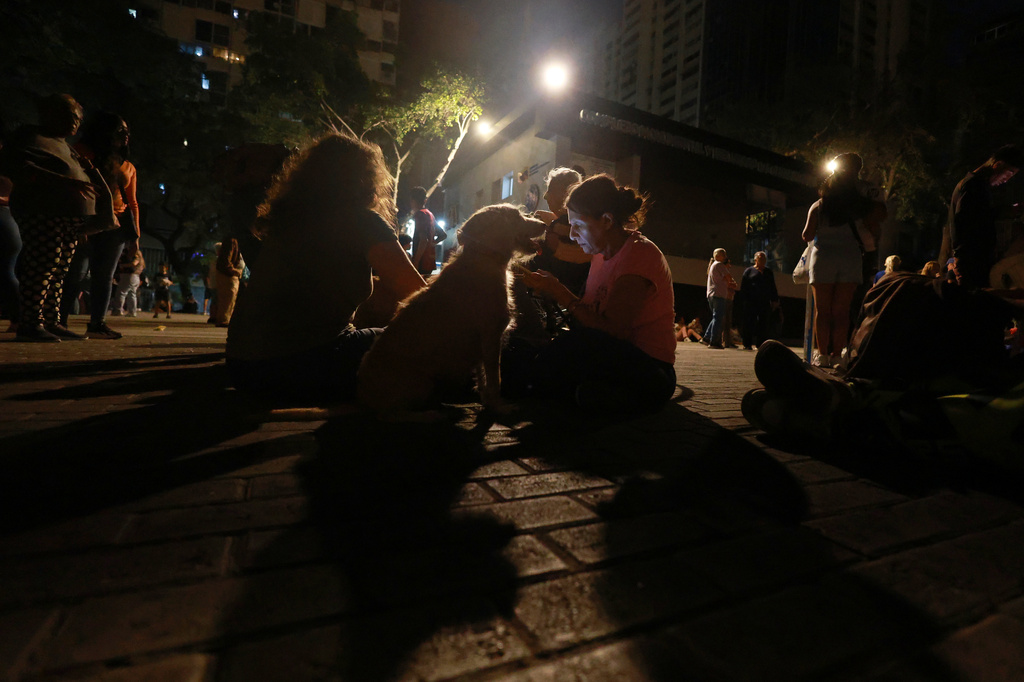 People camp out on a street after an earthquake in Caracas, Venezuela, Wednesday, June 24, 2026. (AP Photo/Javier Campos)