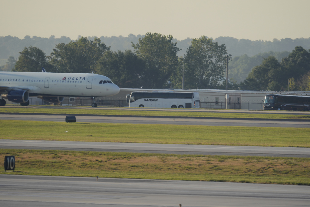 Buses carrying Korean workers detained arrives at Hartsfield-Jackson International Airport in Atlanta, Thursday, Sept. 11, 2025. (AP Photo/George Walker IV)
