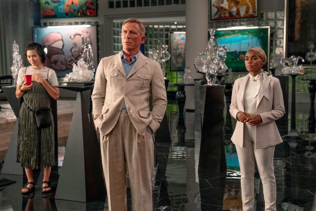 This image released by Netflix shows, from left, Jessica Henwick, Daniel Craig, and Janelle Monáe in a scene from "Glass Onion: A Knives Out Mystery." (John Wilson/Netflix via AP)