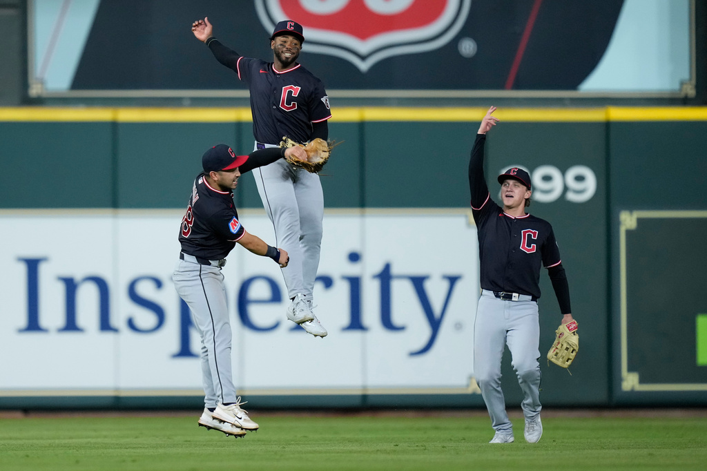Cleveland Guardians left fielder Steven Kwan, right fielder Kahlil Watson and center fielder Petey Halpin celebrate after a baseball game against the Houston Astros, Saturday, June 20, 2026, in Houston. (AP Photo/Kevin M. Cox)