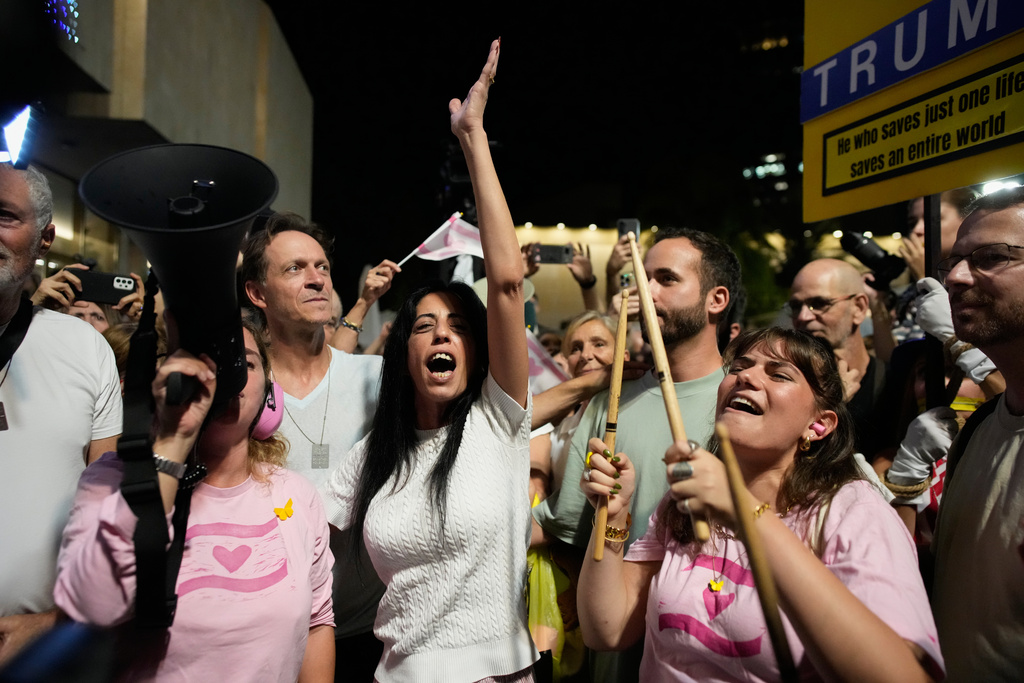 Einav Zangauker, center, mother of Matan Zangauker, who is being held hostage by Hamas, reacts as she and others celebrate following the announcement that Israel and Hamas have agreed to the first phase of a peace plan to pause the fighting, at a plaza known as Hostages Square in Tel Aviv, Israel, Thursday, Oct. 9, 2025. (AP Photo/Ohad Zwigenberg)