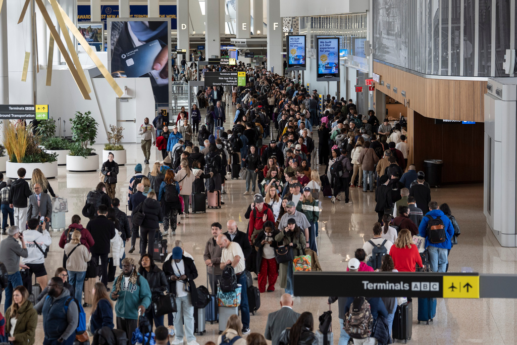 Travelers wait in a TSA line, Wednesday, March 25, 2026, at LaGuardia Airport in New York. (AP Photo/Yuki Iwamura)