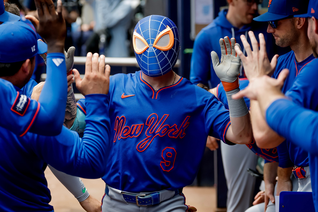 New York Mets' A.J. Ewing (9) wears a Spider-Man mask while celebrating after his solo home run against the Atlanta Braves during the second inning of a baseball game, Sunday, July 5, 2026, in Atlanta. (AP Photo/Erik S. Lesser)