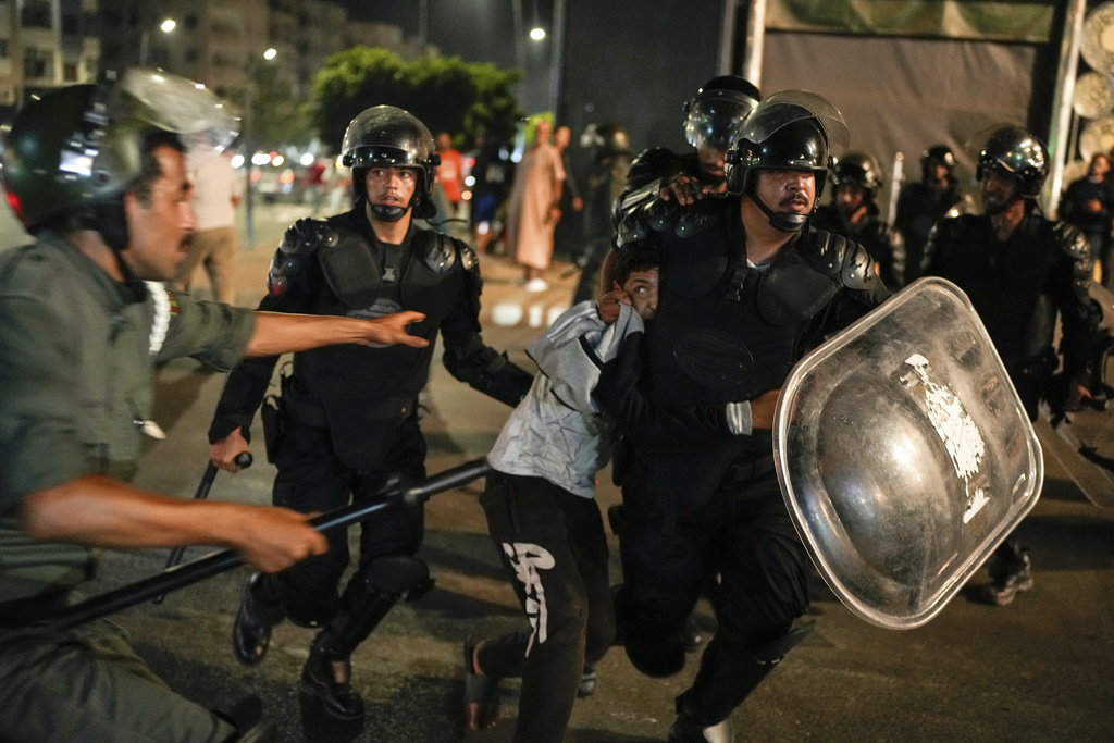 A boy is detained as youth led protests calling for healthcare and education reforms turned violent, in Sale, Morocco, Wednesday, Oct. 1, 2025. (AP Photo/Mosa'ab Elshamy)