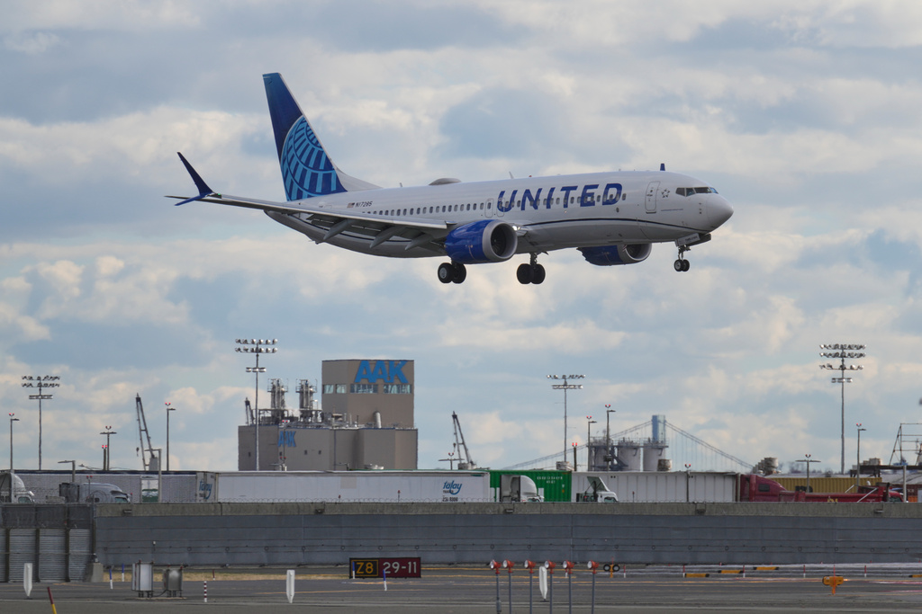 A plane lands at Newark International Airport in Newark, N.J., Thursday, Nov. 6, 2025. (AP Photo/Seth Wenig)