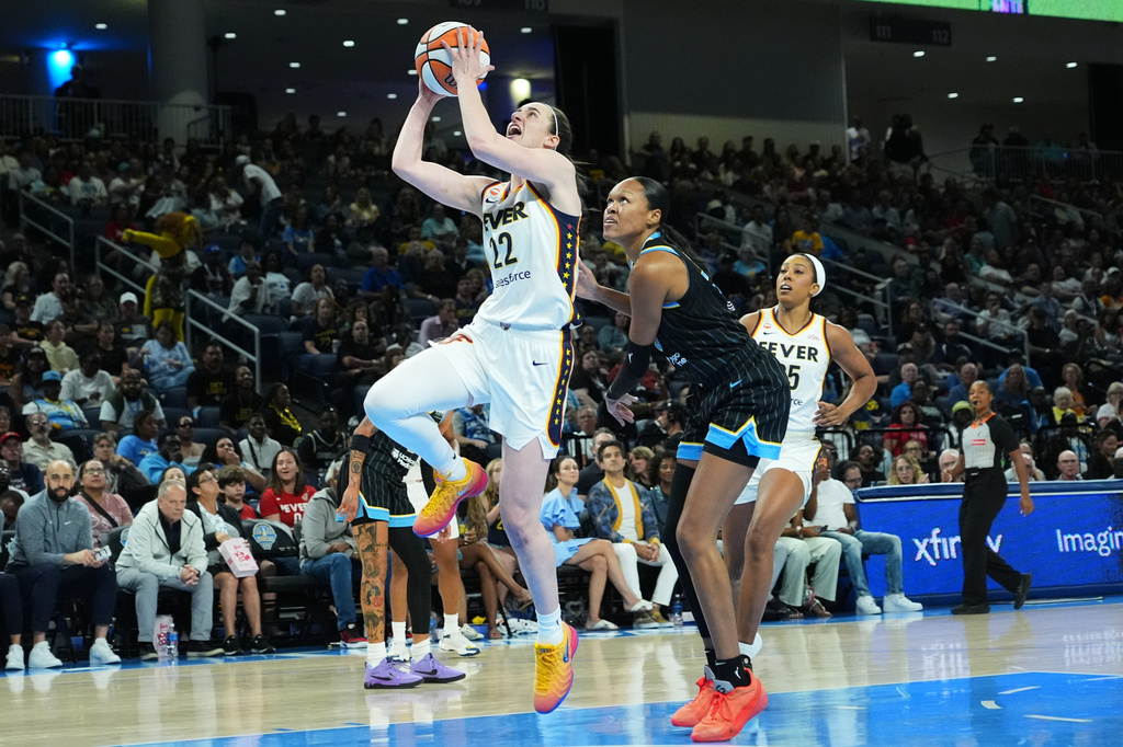 Indiana Fever guard Caitlin Clark, center left, drives to the basket past Chicago Sky forward/center Azura Stevens, center right, during the first half of a WNBA basketball game Sunday, Aug. 23, 2026, in Chicago. (AP Photo/Nam Y. Huh)