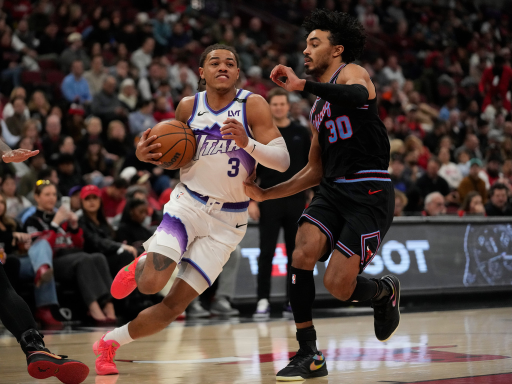 Chicago Bulls guard Tre Jones (30), right, guards Utah Jazz guard Keyonte George (3) during the second half of an NBA basketball game Wednesday, Jan. 14, 2026, in Chicago. (AP Photo/Erin Hooley)