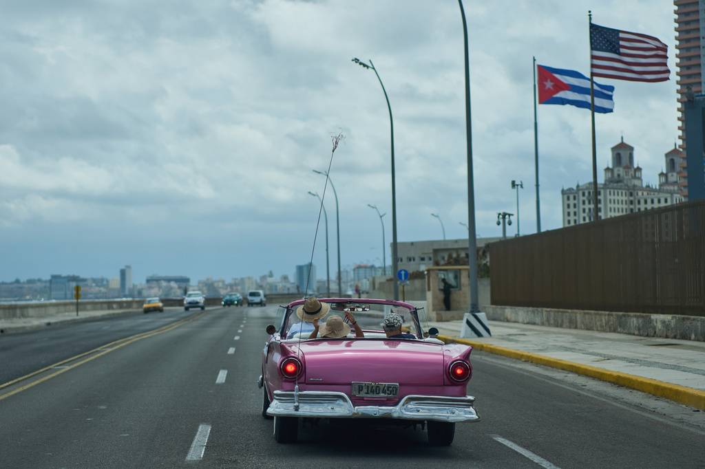 A classic American car carryies tourists past the U.S. Embassy in Havana, Monday, April 20, 2026. (AP Photo/Ramon Espinosa)