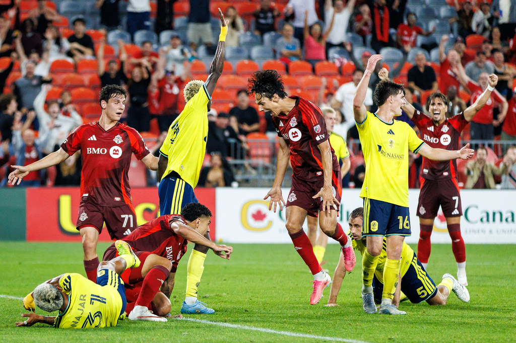 Toronto FC's Daniel Salloi (centre) celebrates after Emilio Aristizabal (bottom, second left) scored against Nashville SC during the second half of a MLS soccer game in Toronto, Wednesday, Sept. 9, 2026. (Keito Newman/The Canadian Press via AP)