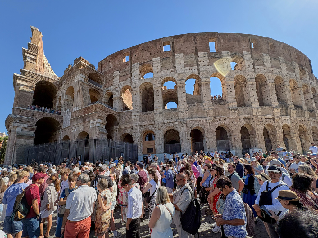 Tourists wait outside the Colosseum, closed to the public for the day to mourn a worker who fell to his death late Tuesday while installing cabling inside the ancient amphitheater, in Rome, Wednesday, Sept. 23, 2026. (AP Photo/Domenico Stinellis)