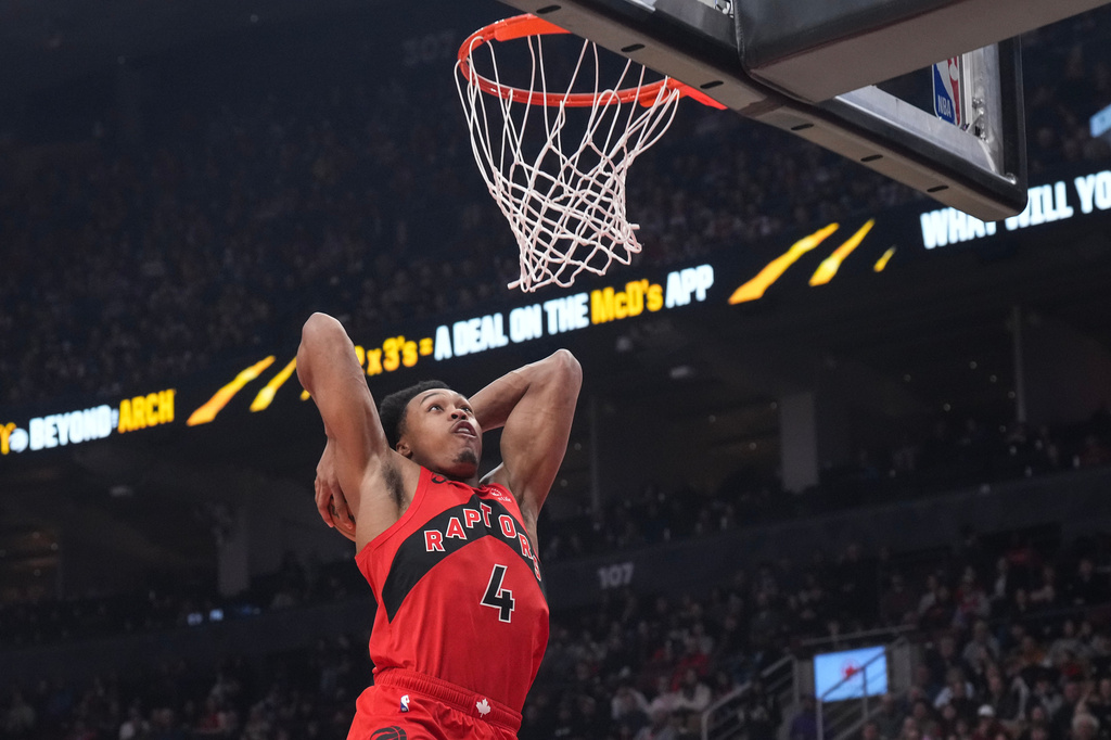 Toronto Raptors' Scottie Barnes (4) scores during the first half of an NBA basketball game against the Dallas Mavericks, in Toronto, Sunday, March 8, 2026. (Chris Young/The Canadian Press via AP)