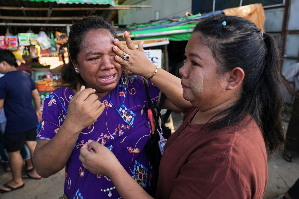 A woman released from Insein prison, right, is welcomed by her family member in Yangon, Myanmar, Thursday, Nov. 27, 2025, after Myanmar's military rulers granted a mass amnesty ahead of elections. (AP Photo/Thein Zaw)