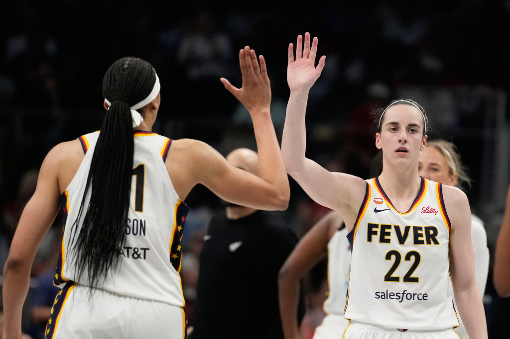 Indiana Fever guard Caitlin Clark (22) high-fives teammates in the overtime during an WNBA basketball game against the Atlanta Dream Sunday, Aug. 16, 2026, in Atlanta. (AP Photo/Brynn Anderson)