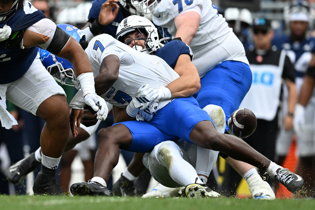 Penn State linebacker Caleb Bacon (10) causes a fumble by Buffalo quarterback Jason Wright (7) during the first quarter of an NCAA college football game, Saturday, Sept. 19, 2026, in State College, Pa. (AP Photo/Barry Reeger)