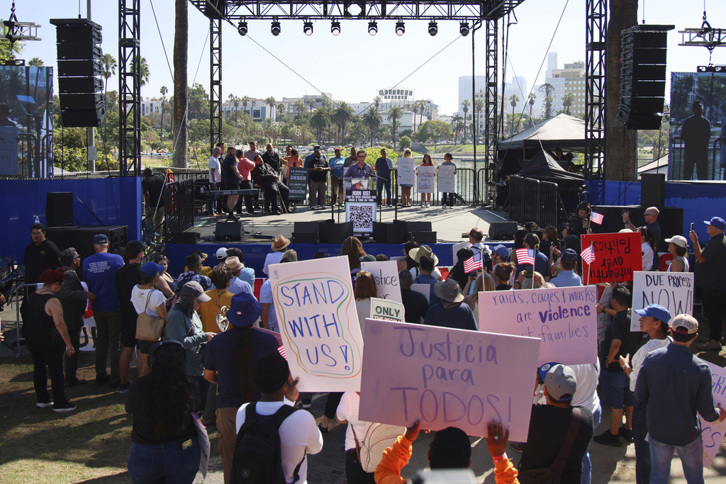 Supporters gather around a stage during an immigration rally on Saturday, Sept. 20, 2025, in Los Angeles. (AP Photo/Ethan Swope)
