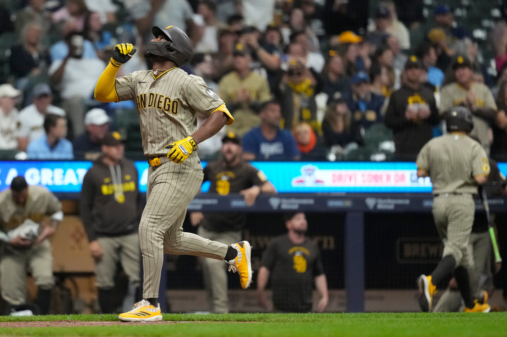San Diego Padres' Miguel Andujar gestures as he rounds the bases after hitting a solo home run during the sixth inning of a baseball game against the Milwaukee Brewers, Tuesday, May 12, 2026, in Milwaukee. (AP Photo/Aaron Gash)