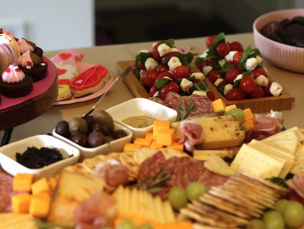 /// An arrangement of crackers, cheeses, meats, fruits and spreads is prepared for guests with other snacks at a gathering of friends at an apartment in Flagstaff, Ariz., on Sunday, Feb. 15, 2026. (AP Photo/Cheyanne Mumphrey)