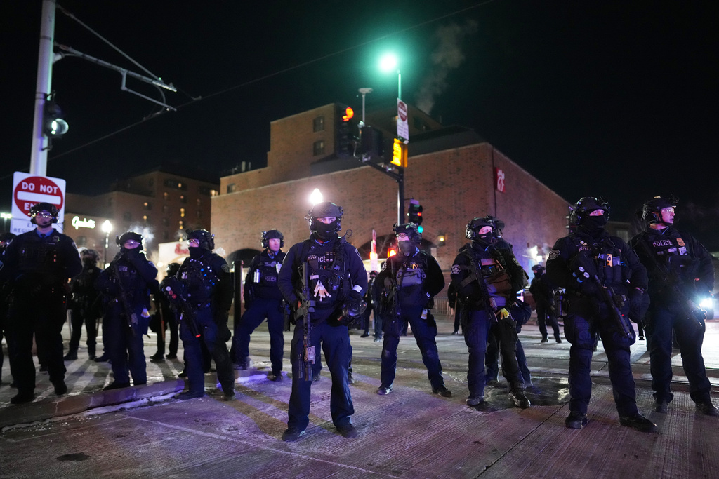 Law enforcement officers prepare to make arrests after declaring an unlawful assembly during a noise demonstration outside the Graduate by Hilton Minneapolis hotel on Wednesday, Jan. 28, 2026, in Minneapolis. (AP Photo/Adam Gray)