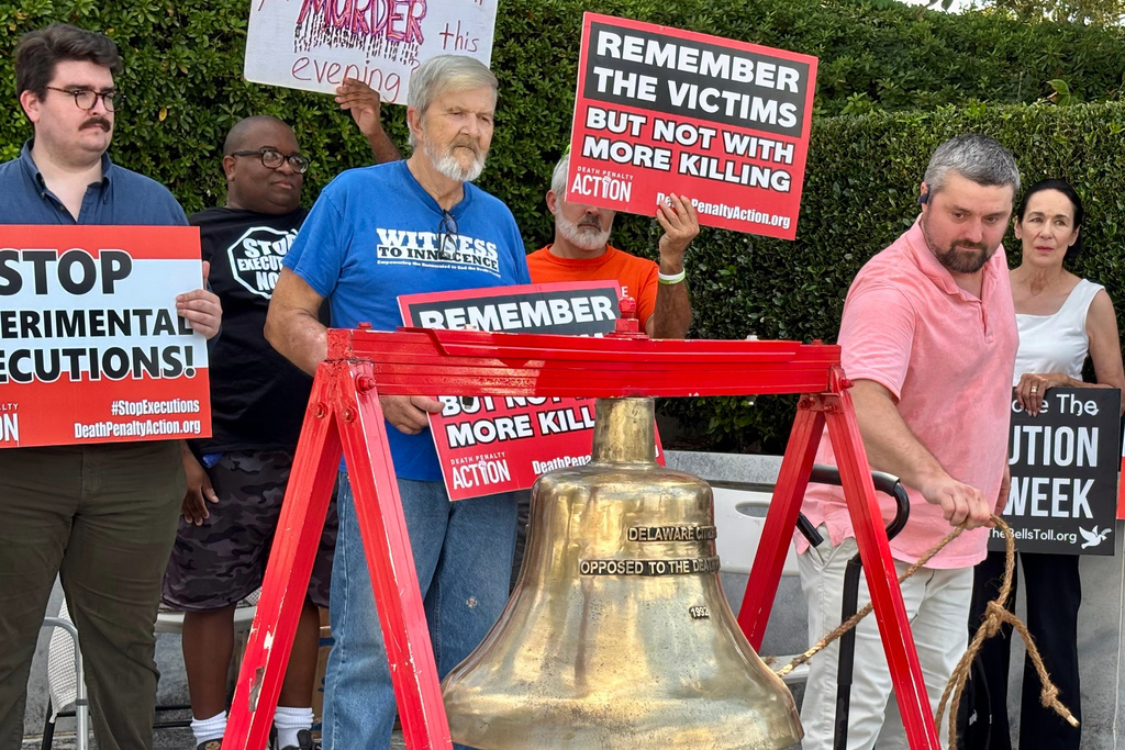 Will Berry rings a bell to symbolize opposition to the death penalty during a protest outside the Capitol in Montgomery, Ala., on Tuesday, Sept. 23,2025. (AP Photo/Kim Chandler)