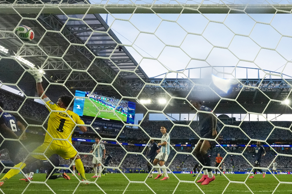 Cape Verde goalkeeper Vozinha (1) is scored on by Argentina's Lisandro Martinez during the World Cup round of 32 soccer match between Argentina and Cape Verde in Miami Gardens, Fla., Friday, July 3, 2026. (AP Photo/Lynne Sladky)
