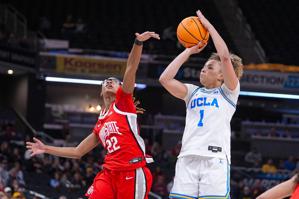 UCLA guard Kiki Rice (1) shoots over Ohio State guard Jaloni Cambridge (22) in the second half of an NCAA college basketball game in the semifinals of the Big Ten Conference tournament, Saturday, March 7, 2026 in Indianapolis. (AP Photo/Michael Conroy)