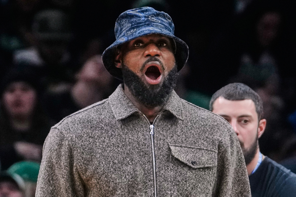 Los Angeles Lakers' Lebron James yawns while standing next to the bench during an NBA basketball game against the Boston Celtics, Friday, Dec. 5, 2025, in Boston. (AP Photo/Charles Krupa)