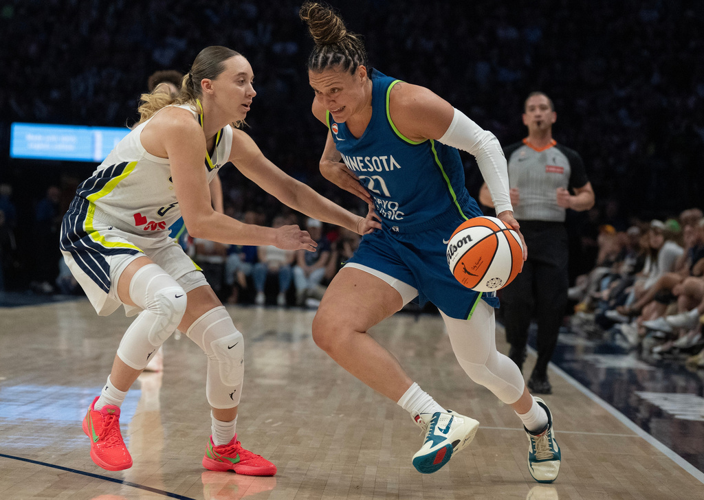 Minnesota Lynx guard Kayla McBride (21) drives to the basket on Dallas Wings guard Paige Bueckers in the first half of a basketball game, Sunday Aug. 9, 2026 in Minneapolis. (Jerry Holt/Minnesota Star Tribune via AP)