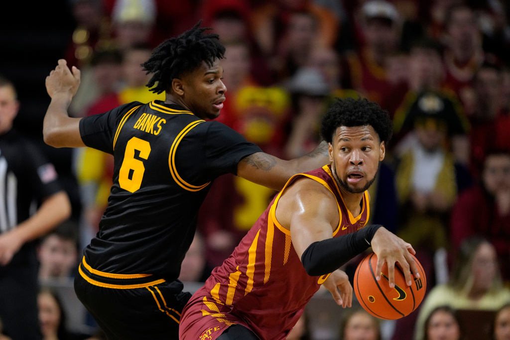 Iowa State forward Joshua Jefferson, right, drives around Iowa guard Tavion Banks (6) during the first half of an NCAA college basketball game, Thursday, Dec. 11, 2025, in Ames, Iowa. (AP Photo/Charlie Neibergall)