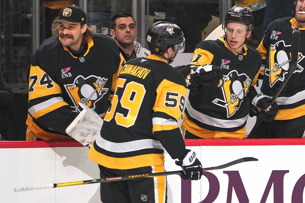 Pittsburgh Penguins' Egor Chinakhov (59) returns to the bench after scoring during the second period of an NHL hockey game against the Vegas Golden Knights in Pittsburgh, Sunday, March 1, 2026. (AP Photo/Gene J. Puskar)