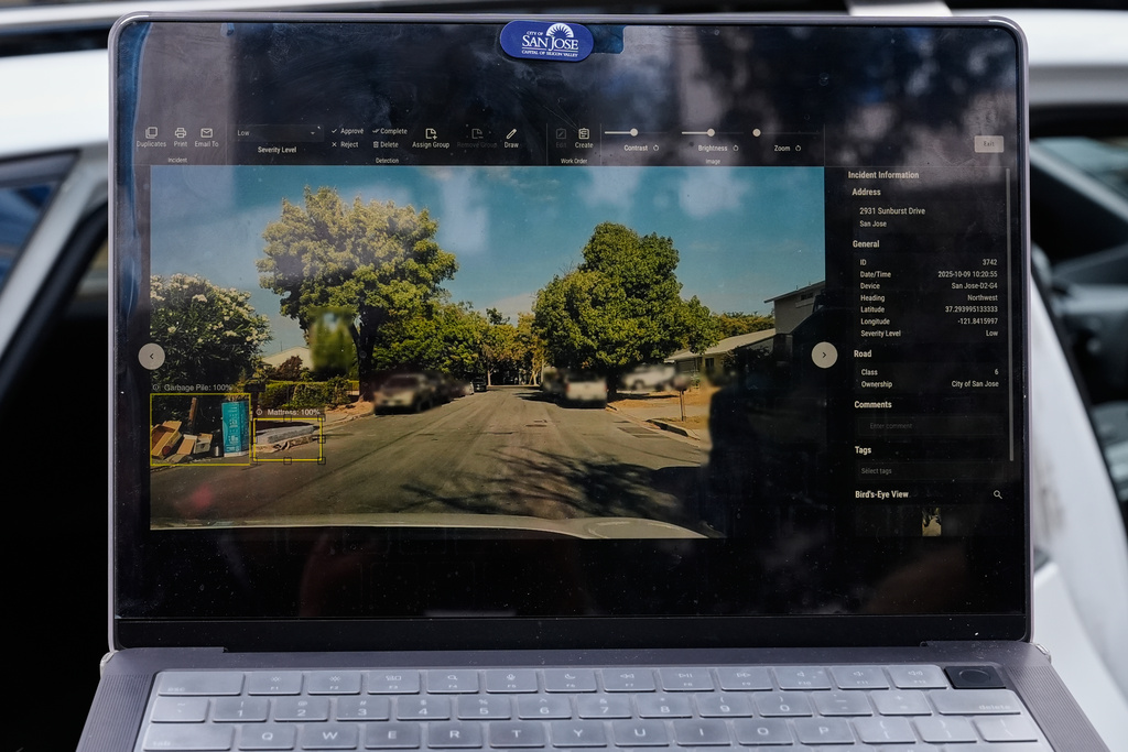 Chelsea Palacio, public information manager for the City of San Jose, showcases how a small detection camera uses AI to detect road hazards and potholes in San Jose, Calif., Wednesday, Nov. 12, 2025. (AP Photo/Godofredo A. Vásquez)