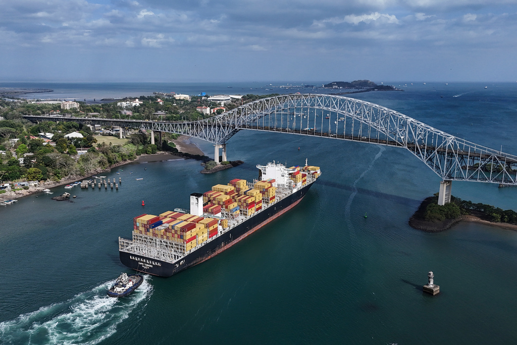 A cargo ship sails under Las Americas bridge through the Panama Canal, in Panama City, Thursday, March 12, 2026. (AP Photo/Matias Delacroix)