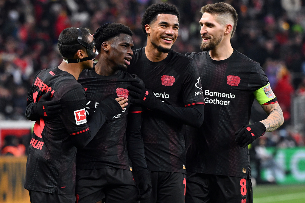 Leverkusen's Ernest Poku, second from left, celebrates with Arthur, left, Malik Tillman, centre right, and Robert Andrich after scoring his side's fourth goal during the German Bundesliga soccer match between Bayer Leverkusen and FC St. Pauli, in Leverkusen, Germany, Saturday, Dec. 14, 2026. (Federico Gambarini/dpa via AP)