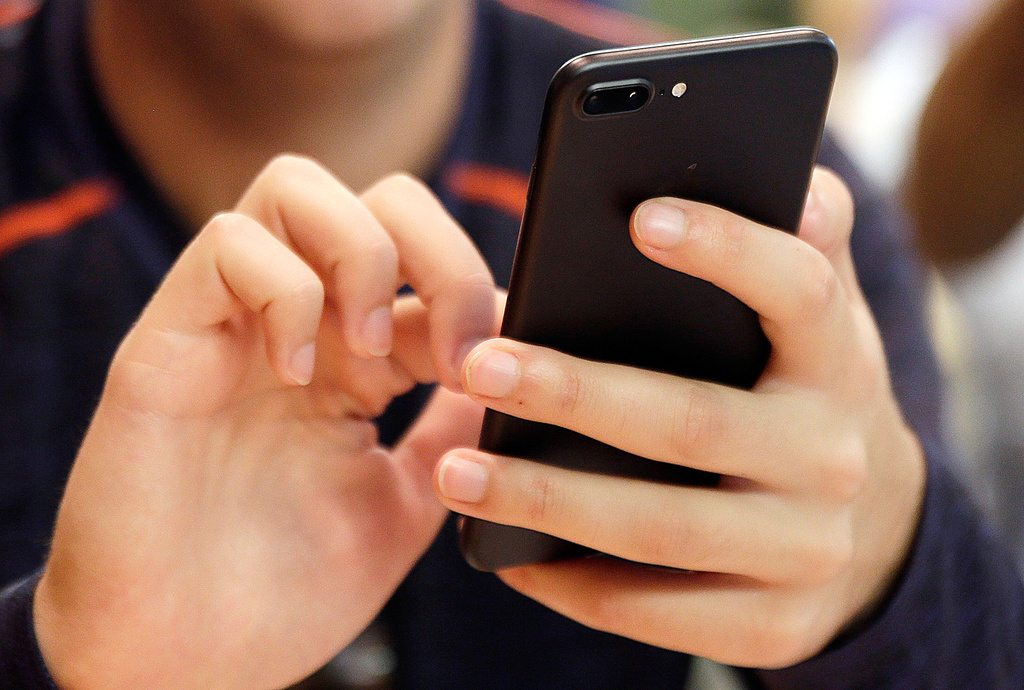 FILE - A person uses a smartphone in Chicago, Sept. 16, 2017. (AP Photo, File)
