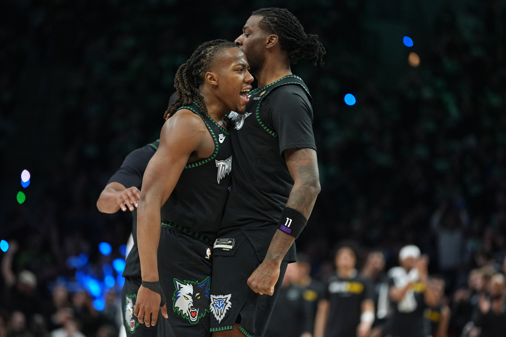 Minnesota Timberwolves guard Ayo Dosunmu, left, celebrates with center Naz Reid, right, after making a 3-point basket during the second half of Game 4 of a first-round NBA basketball playoff series against the Denver Nuggets, Saturday, April 25, 2026, in Minneapolis. (AP Photo/Abbie Parr)